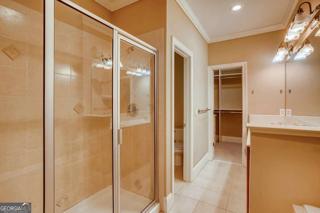 full bath featuring ornamental molding, a shower stall, toilet, vanity, and tile patterned flooring