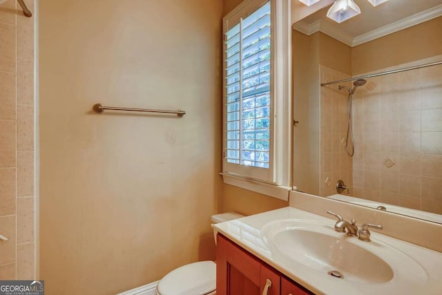 bathroom featuring crown molding, a shower, vanity, and toilet