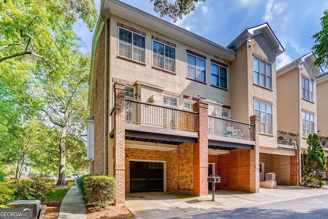 view of property with an attached garage and concrete driveway