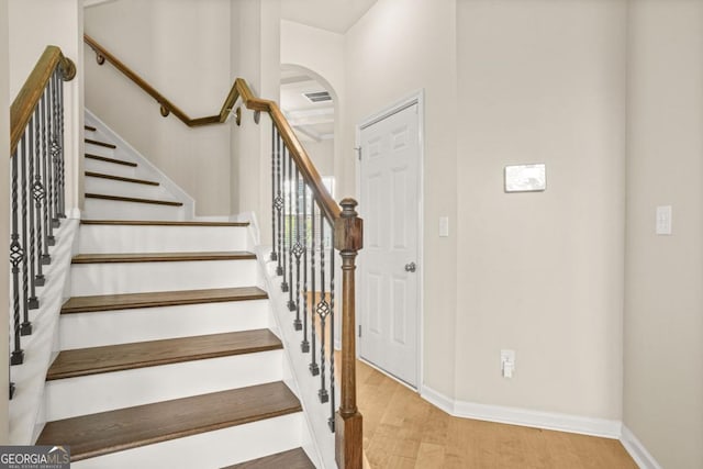 321 Shannon Ct, Mcdonough, GA 30252 - stairway featuring wood finished floors, baseboards, and arched walkways