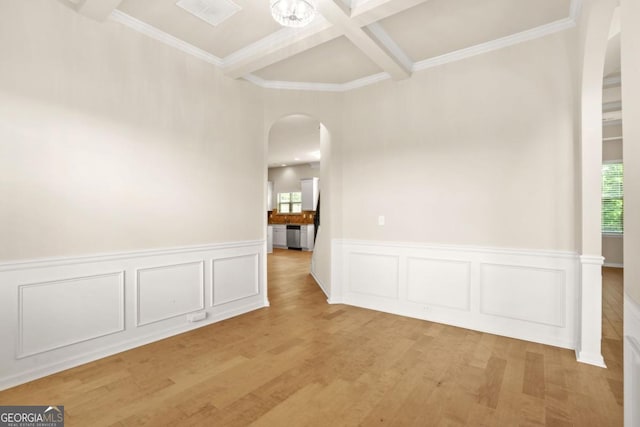 321 Shannon Ct, Mcdonough, GA 30252 - empty room with arched walkways, healthy amount of natural light, beamed ceiling, light wood-style flooring, and coffered ceiling