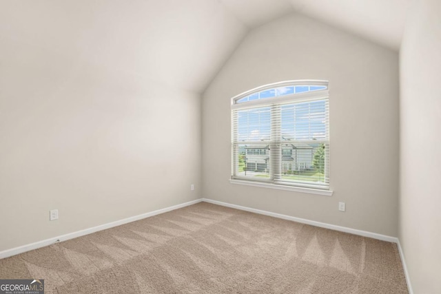 321 Shannon Ct, Mcdonough, GA 30252 - carpeted empty room with baseboards and lofted ceiling