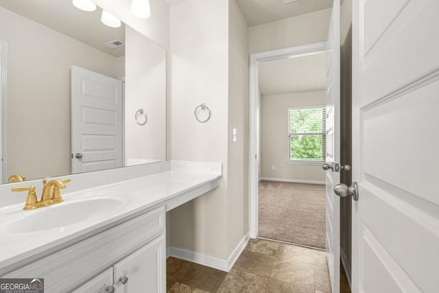 321 Shannon Ct, Mcdonough, GA 30252 - bathroom featuring vanity, baseboards, and stone finish flooring