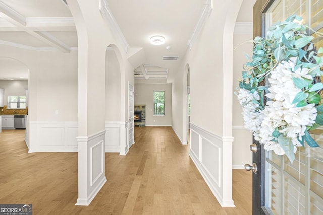 321 Shannon Ct, Mcdonough, GA 30252 - foyer entrance with crown molding, beam ceiling, light wood-type flooring, a wainscoted wall, and a decorative wall