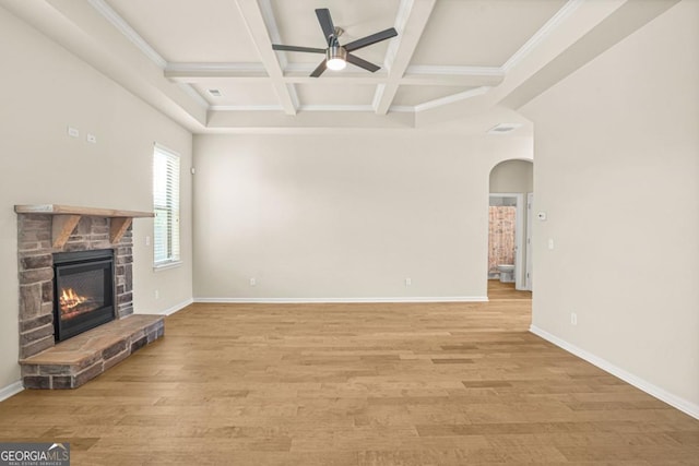321 Shannon Ct, Mcdonough, GA 30252 - unfurnished living room with arched walkways, ceiling fan, coffered ceiling, beamed ceiling, and a fireplace