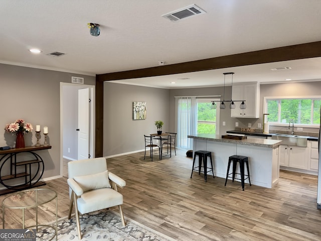 2093 Double Bridge Rd, Demorest, GA 30535 - kitchen with a sink, a center island, white cabinetry, light wood-type flooring, and recessed lighting