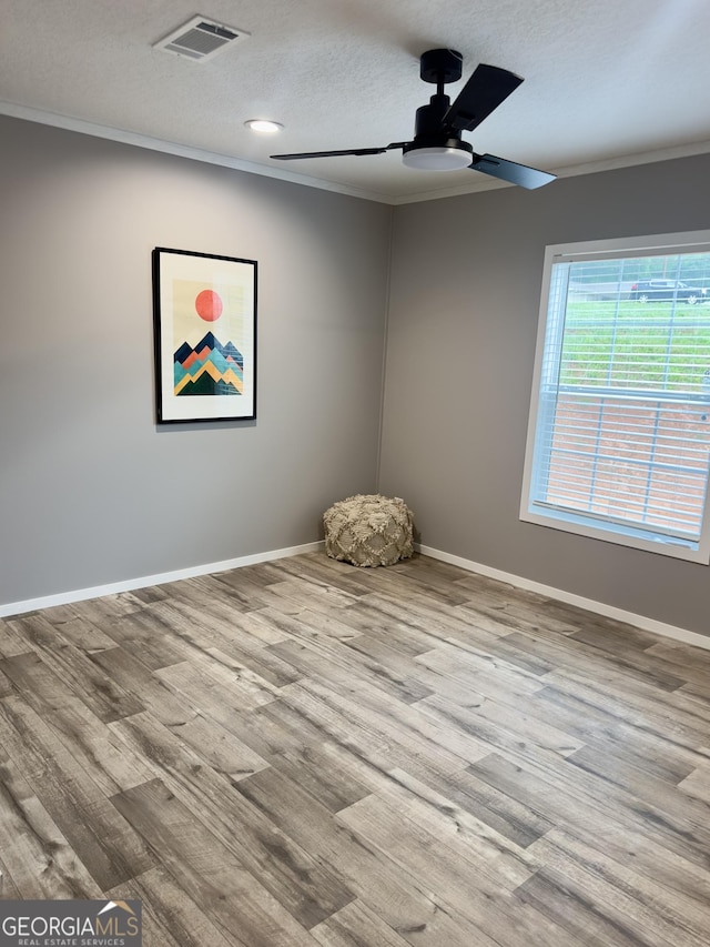 2093 Double Bridge Rd, Demorest, GA 30535 - spare room featuring a ceiling fan, crown molding, wood finished floors, baseboards, and a textured ceiling