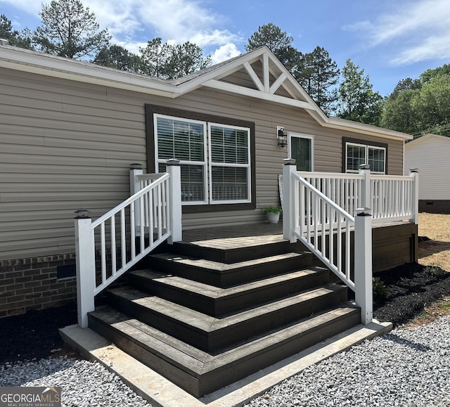 property entrance with a wooden deck and crawl space