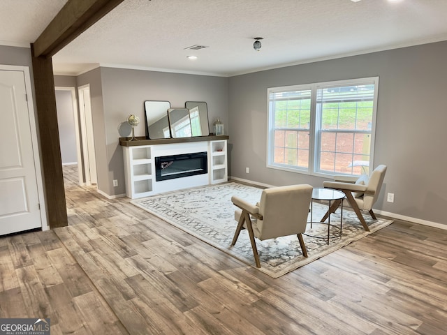 2093 Double Bridge Rd, Demorest, GA 30535 - living room with ornamental molding, wood finished floors, baseboards, a glass covered fireplace, and recessed lighting