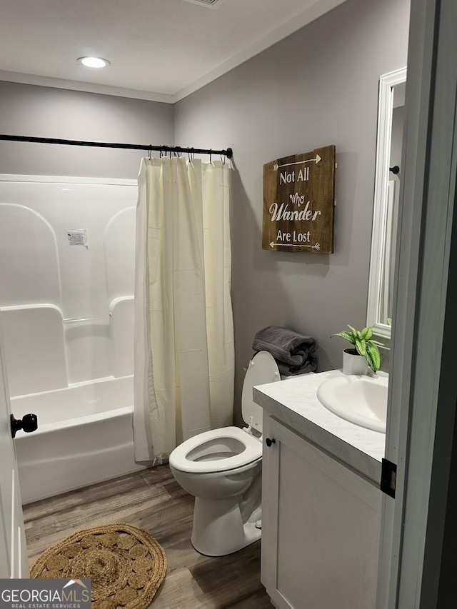 full bathroom with wood finished floors, toilet, shower / bath combination with curtain, vanity, and recessed lighting