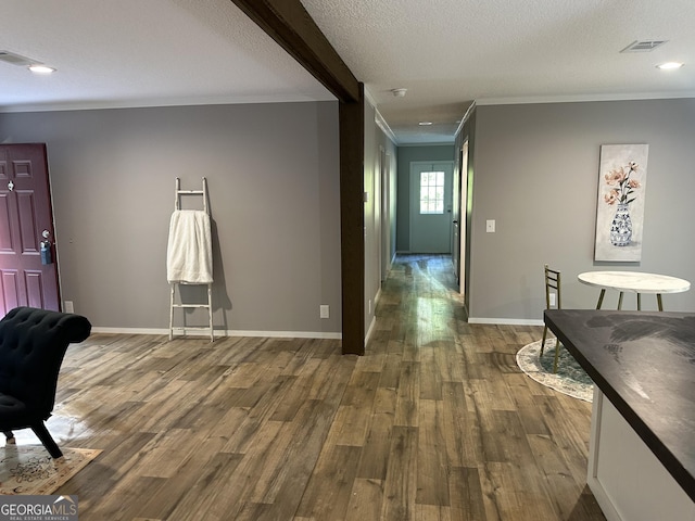 living room featuring ornamental molding, wood finished floors, baseboards, recessed lighting, and a textured ceiling