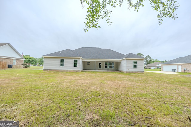 back of property featuring a yard