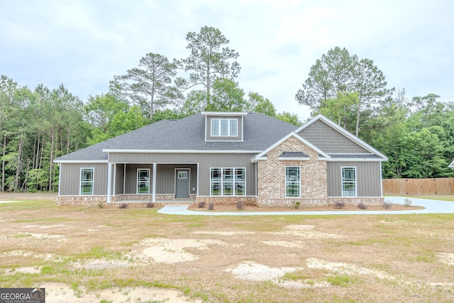 view of front of house with a porch and roof with shingles