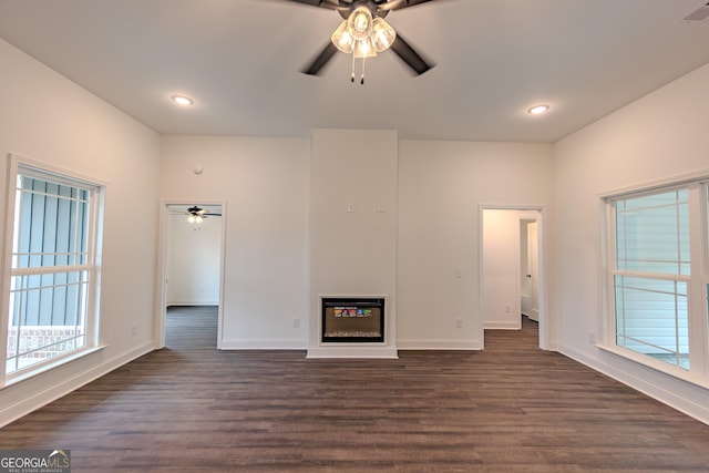 unfurnished living room featuring a ceiling fan, dark wood-style flooring, healthy amount of natural light, and recessed lighting