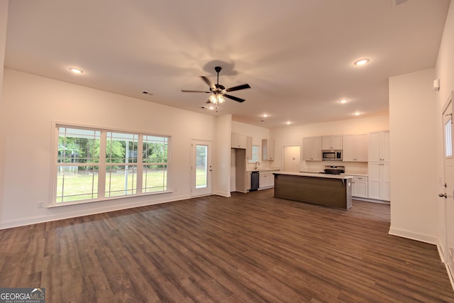 unfurnished living room featuring dark wood finished floors, baseboards, recessed lighting, and ceiling fan