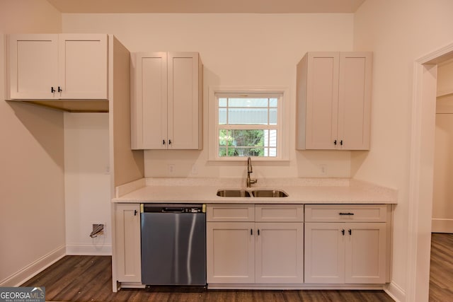 kitchen with dishwasher, a sink, dark wood finished floors, baseboards, and white cabinetry