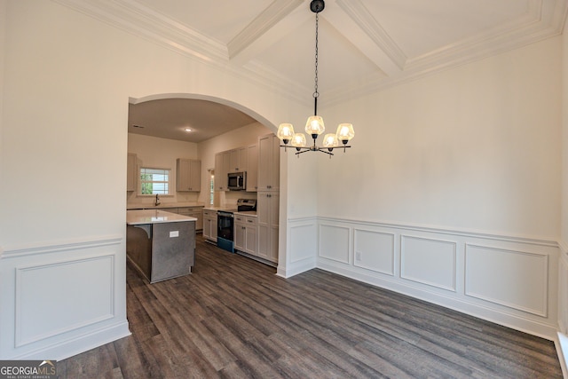 kitchen with appliances with stainless steel finishes, a chandelier, arched walkways, light countertops, and dark wood-type flooring