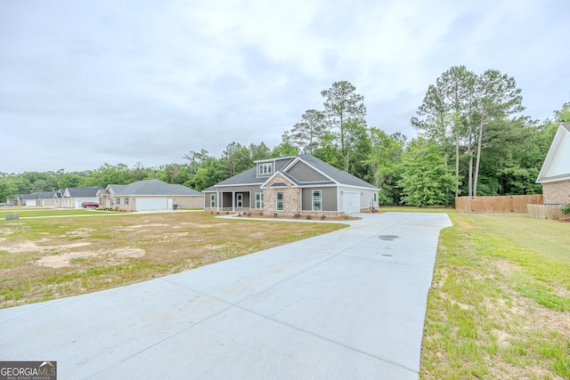 craftsman inspired home featuring a garage, driveway, and covered porch