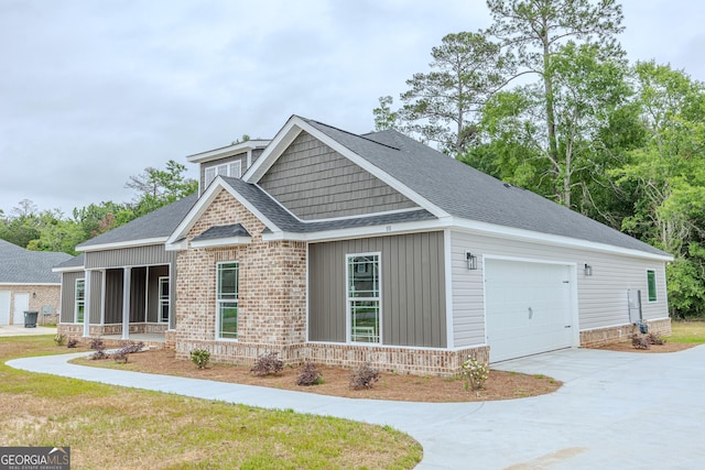craftsman-style house with a shingled roof, driveway, brick siding, and a garage