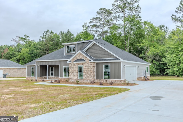 craftsman-style house featuring a porch, a front yard, driveway, and roof with shingles