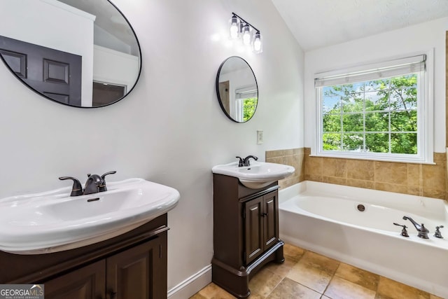 870 Underhill Ct, Sugar Hill, GA 30518 - full bathroom featuring vaulted ceiling, a garden tub, and two vanities