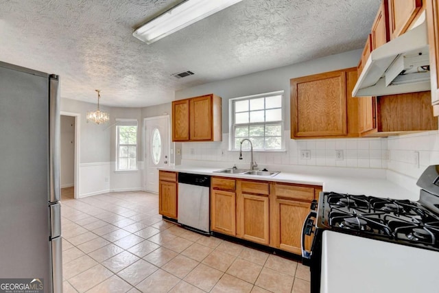2355 Glen Chase Ln, Lawrenceville, GA 30044 - kitchen with a sink, stainless steel appliances, under cabinet range hood, plenty of natural light, and a textured ceiling