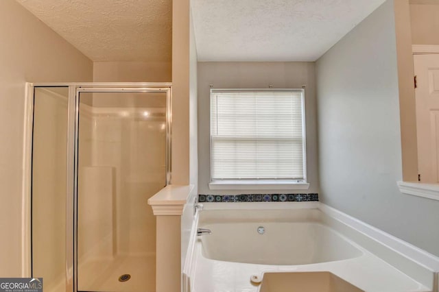2355 Glen Chase Ln, Lawrenceville, GA 30044 - bathroom featuring a shower stall, a textured ceiling, and a garden tub