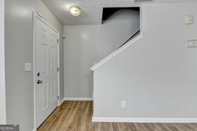 2355 Glen Chase Ln, Lawrenceville, GA 30044 - entrance foyer with wood finished floors, a textured ceiling, and baseboards