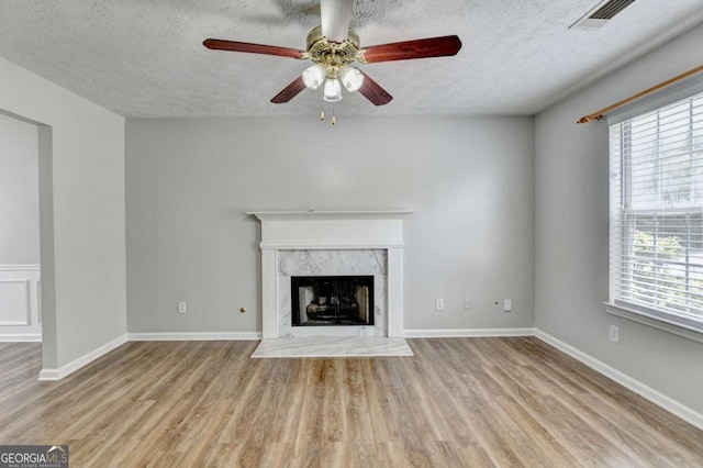 2355 Glen Chase Ln, Lawrenceville, GA 30044 - unfurnished living room featuring a ceiling fan, a textured ceiling, wood finished floors, a fireplace, and baseboards