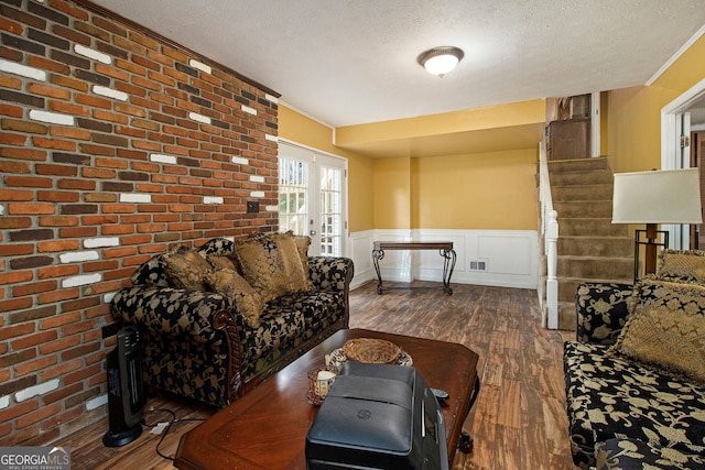 2950 Springfield Ct SW, College Park, GA 30349 - living room with wood finished floors, a wainscoted wall, a textured ceiling, stairway, and crown molding