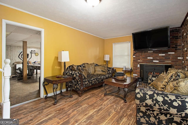 2950 Springfield Ct SW, College Park, GA 30349 - living area featuring wood finished floors, a textured ceiling, a fireplace, baseboards, and ornamental molding