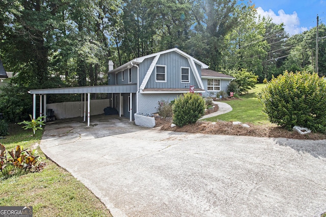 2950 Springfield Ct SW, College Park, GA 30349 - view of front facade with a front yard, brick siding, a chimney, concrete driveway, and an attached carport