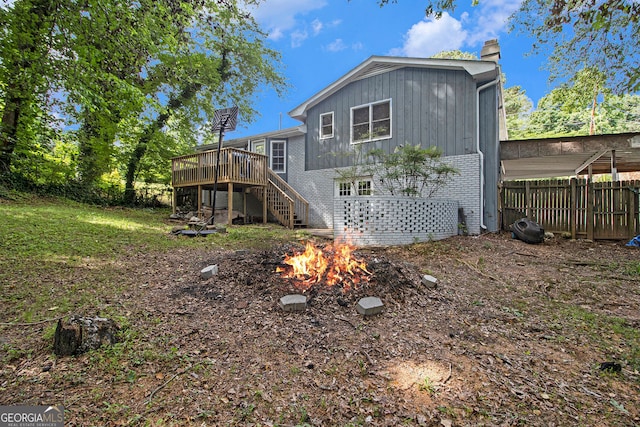 2950 Springfield Ct SW, College Park, GA 30349 - rear view of house with a chimney, stairs, a wooden deck, an outdoor fire pit, and brick siding