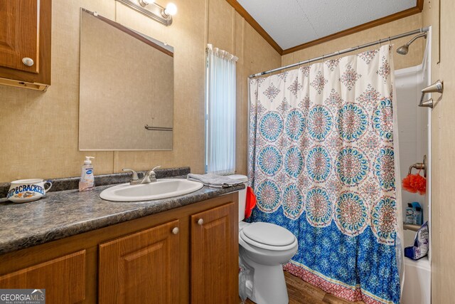 bathroom with ornamental molding, a shower with curtain, toilet, wood finished floors, and vanity