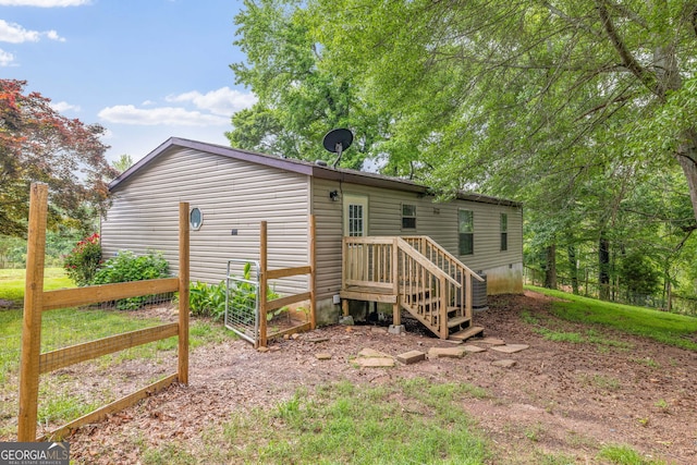back of property with fence and cooling unit