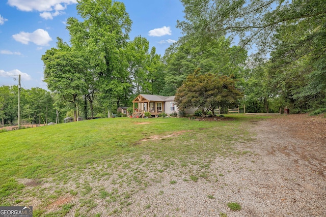 view of grassy yard with a deck