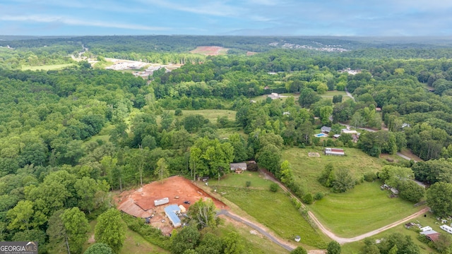 view of property location with a forest