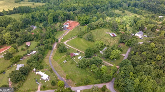 view of property location featuring a forest