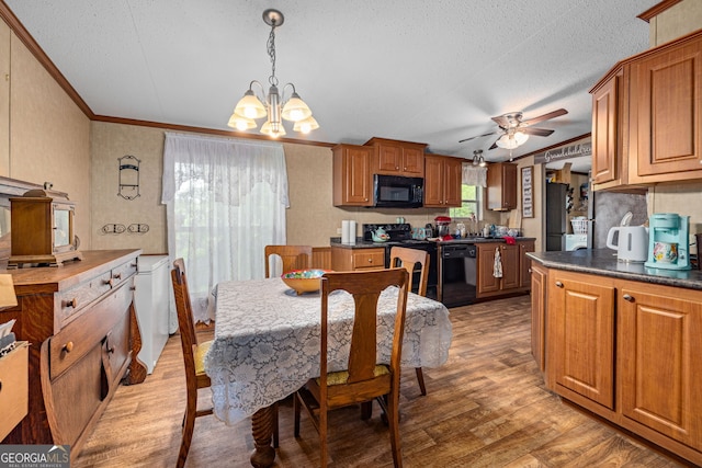 dining space featuring a textured ceiling, ornamental molding, a chandelier, light wood-style floors, and a ceiling fan