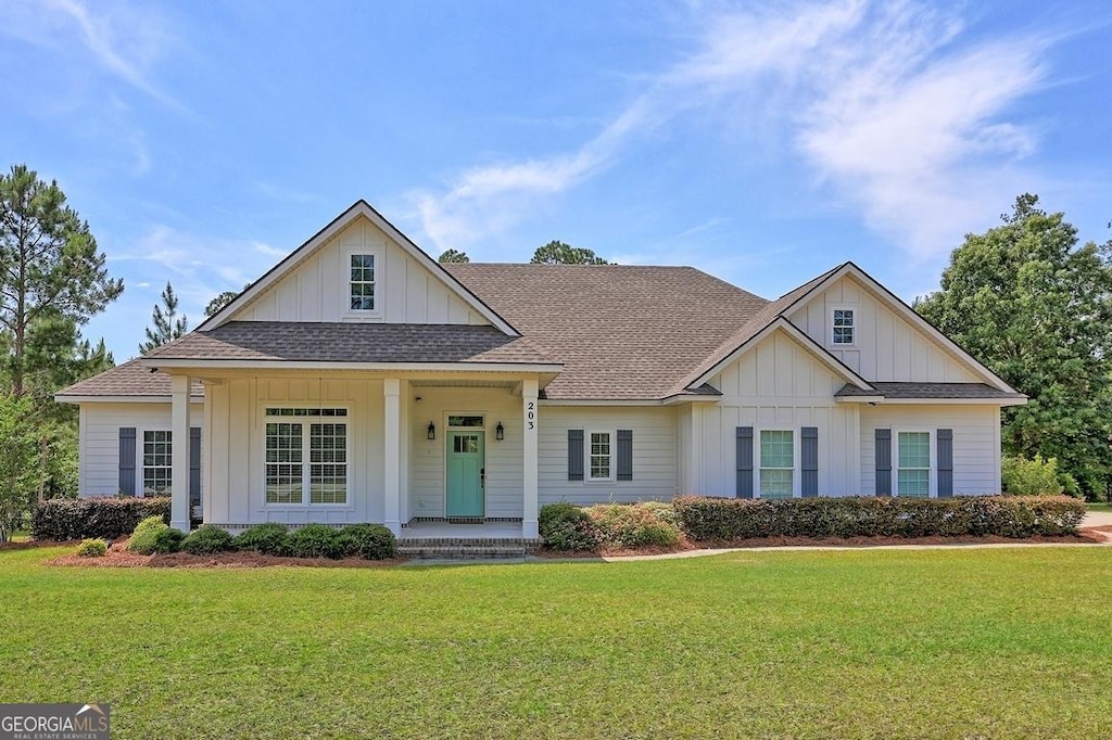 203 Youngblood Rd, Statesboro, GA 30461 - modern farmhouse with board and batten siding, a shingled roof, a front lawn, and covered porch