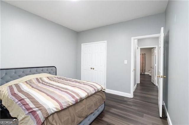 2221 Baker Carter Dr, Loganville, GA 30052 - bedroom with baseboards, dark wood finished floors, and a closet
