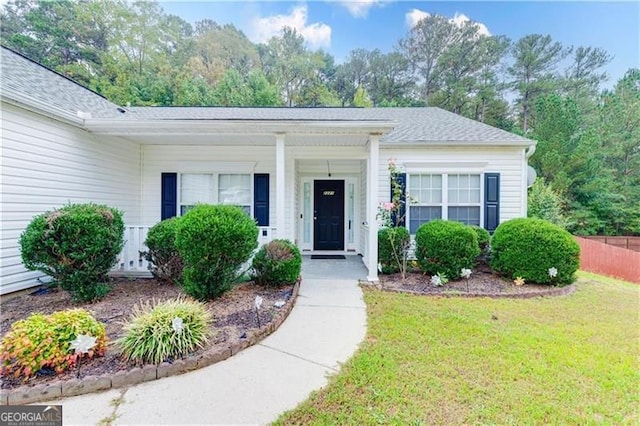 2221 Baker Carter Dr, Loganville, GA 30052 - view of exterior entry with a lawn and a porch