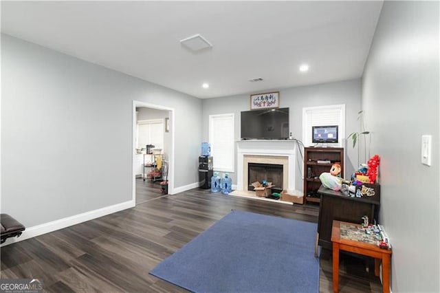 2221 Baker Carter Dr, Loganville, GA 30052 - living room featuring baseboards, a fireplace with raised hearth, wood finished floors, and recessed lighting