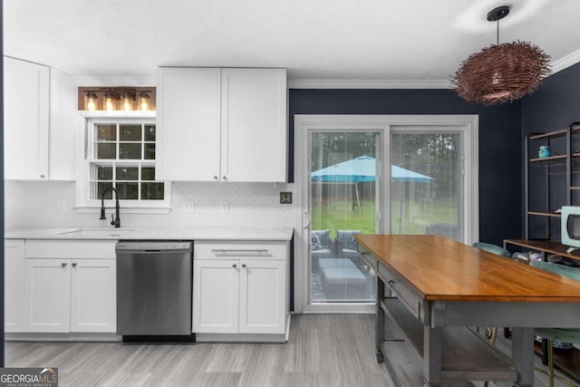 kitchen with dishwasher, a sink, white cabinetry, light wood-style flooring, and crown molding