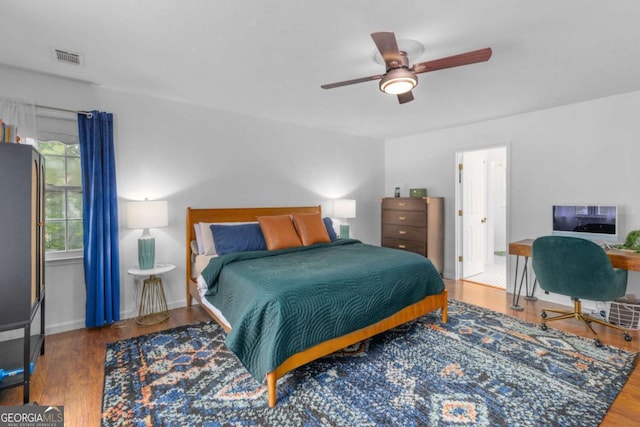 bedroom featuring wood finished floors, ceiling fan, and baseboards