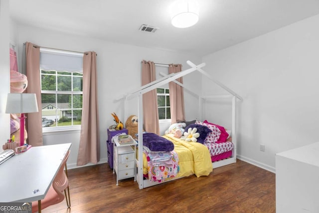 bedroom featuring wood finished floors and baseboards