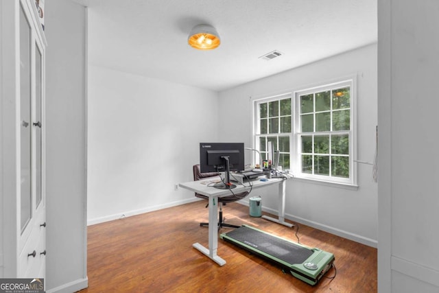 office space featuring wood finished floors and baseboards