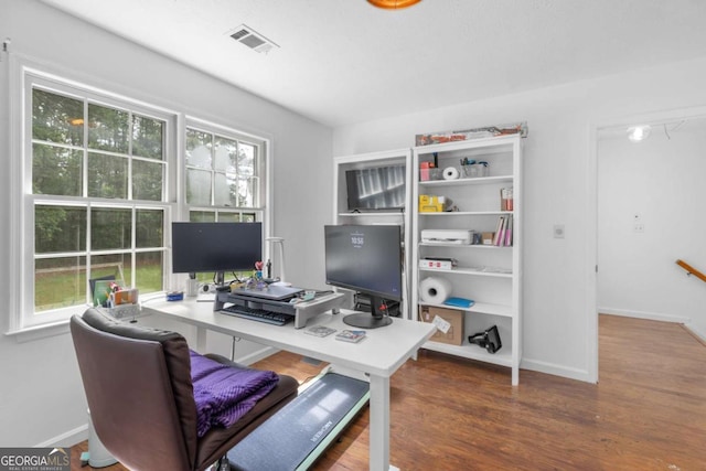 office space with wood finished floors and baseboards