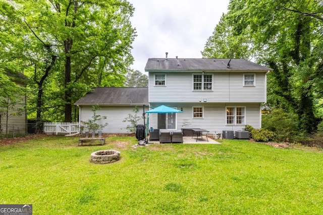 back of property featuring central air condition unit, a patio, and an outdoor living space with a fire pit