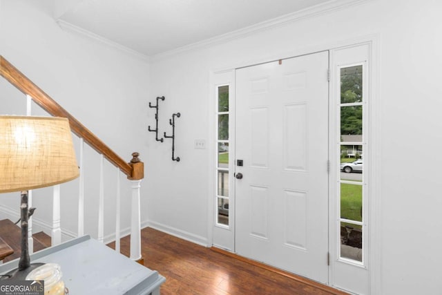 entrance foyer featuring wood finished floors, stairs, and ornamental molding